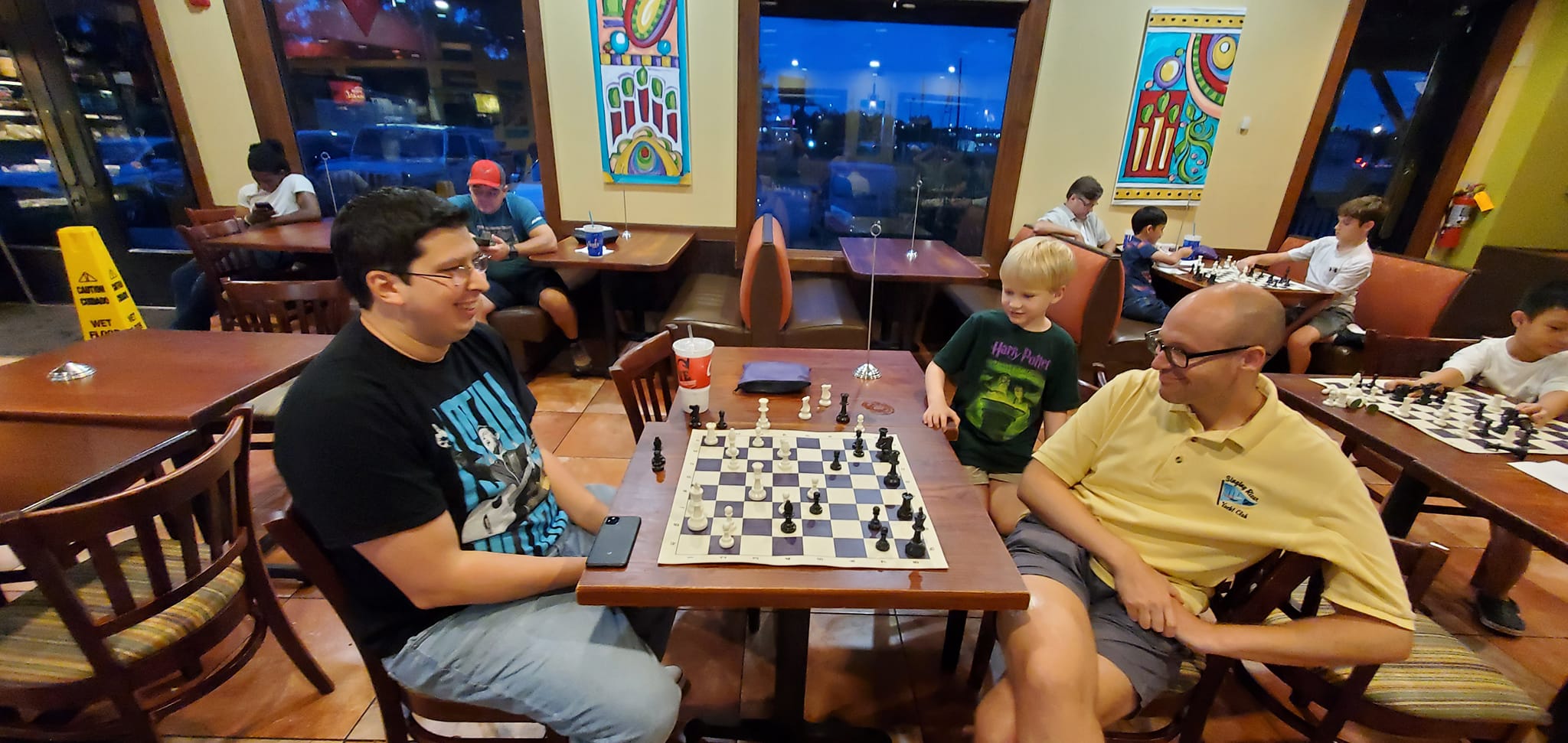 Folks having a good time playing chess.